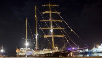 Sailing yacht RUNNING ON WAVES -  At Night